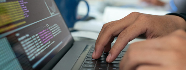 Close up hands typing on a keyboard